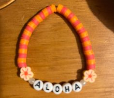 Pink and Orange Aloha Bracelet - Handmade with Claybeads Moana Bracelet Ideas, Orange Letter Beads For Beach, Hand-strung Orange Bracelets For Beach, Orange Bead Bracelet For Beach, Orange Bracelet Beads For Beach, Orange Bead Bracelets For Beach, Orange Beaded Bracelets With Letter Beads For Beach, Orange Beaded Bracelets For Beach, Orange Large Beads Bracelets For Beach