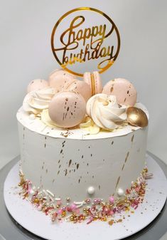 a birthday cake with white frosting and gold sprinkles