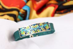 Georgian cloisonne enamel Bracelet on leather  - Fine silver jewelry, statement jewelry This jewelry is 100 % handmade by me in my studio. The technique is called Cloisonne enamel which is well known in Georgia. Many people in my country love buying handmade jewelry because they are unique and special!  ▪️ ▪️ ▪️ About shipping▪️ ▪️ ▪️ The price for this item includes standard shipping cost. Estimated arrival time: 3-4 weeks. ▪️ Delays might occur due to the current situation worldwide. So, pleas Cloisonne Enamel Jewelry, Fine Silver Jewelry, Cloisonne Enamel, Jewelry Statement, Enamel Bracelet, Unisex Bracelets, Enamel Jewelry, Buy Handmade, Bracelet Silver