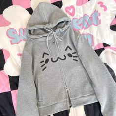 This hoodie features a double-headed zipper closure design, with pockets on both sides of the placket. The garment is adorned with emoticon prints, and the hood comes with a drawstring design. It is a cropped style.  Price includes only one hoodie.   	 		 			Size 			S 			M 		 		 			Length 			51 			52 		 		 			Bust 			94 			98 		 		 			Sleeve Length 			61 			63 Trendy Hoodie With Zipper Closure, Cute Streetwear Outerwear With Drawstring Hood, Trendy Hooded Top With Zipper Closure, Cute Outerwear With Drawstring Hood For Streetwear, Cute Hoodie Outerwear For Streetwear, Casual Outerwear With Cartoon Print, Trendy Hooded Outerwear With Cartoon Print, Cute Hoodie For Streetwear, Comfy Hoodie With Double-lined Hood