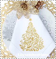 a white and gold christmas tree napkin on top of a doily