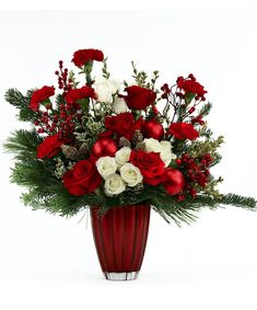 a red vase filled with white and red flowers