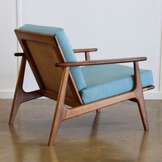 a blue chair sitting on top of a hard wood floor