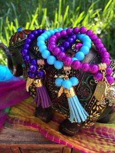 "Go ahead & embellish yourself with this years latest fashion in arm candy with my unique design of bohemian style, prayer bead stackable bracelets!   Choose from every color of the rainbow & see for yourself just what this trendy little style & mix can do for you!!   EACH UNIQUE BRACELET IS BEAUTIFULLY CREATED WITH:  Super strong & durable stretch cord to withstand daily wear ~~22 8mm acrylic colored beads, plus 3 additional hanging acrylic beads 2 Hanging gold charms (1 small & 1 big)  ~~1 mat Bohemian Friendship Bracelets For Meditation, Bohemian Stretch Bracelet With Colorful Beads For Meditation, Bohemian Blue Beaded Bracelets For Meditation, Blue Bohemian Bracelets For Meditation, Bohemian Blue Bracelets For Meditation, Blue Bohemian Beaded Bracelets For Meditation, Hand-strung Bohemian Stretch Bracelet, Blue Bohemian Stretch Bracelet For Meditation, Bohemian Blue Stretch Bracelet For Meditation