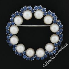 --Stone(s):-- (50) Natural Genuine Sapphires - Old Round Cut - Prong Set - Cornflower Velvety Blue Color - 1.50ctw (approx.) (9) Genuine Cultured Akoya Pearls - Round Shape - Stem Set - White w/ Pink Overtone Color - Excellent Luster - 5mm each (approx.) Material: Solid 18k White Gold Total Weight: 9.15 Grams Overall Diameter:32.3mm (1.2") Overall Thickness: 5.8mm (excluding the pin) Backing: Pin w/ Rotating Closure Condition: Vintage, Retro American. Shows some light wear. Excellent condition! White Gold Round Brooch For Anniversary, White Gold Round Brooches For Anniversary, Fine Jewelry White Gold Round Brooches, Wedding Gemstone Round Brooches, Wedding Gemstone Brooch, Anniversary Round Brooch Jewelry, Akoya Pearls, Elegant Ring, Hinged Bangle