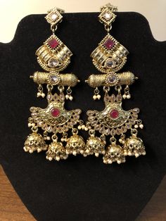 Bollywood Bridal Earrings With Intricate Design For Ceremonial, Bollywood Bridal Earrings With Stone Work For Reception, Bollywood Style Jhumkas With Intricate Design For Reception, Temple Jewelry Bridal Earrings With Stone Work, Bollywood Bridal Sets With Latkans For Festive, Temple Style Chandbalis With Stone Work For Reception, Bollywood Style Wedding Jhumkas With Intricate Design, Bollywood Style Intricate Design Wedding Jhumkas, Bollywood Festive Bridal Earrings For Ceremonies