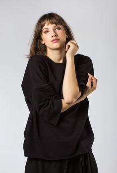 This casual black sweatshirt originally designed by shyzuka. incredibly soft and comfy top. fabric: 95% cotton, 5% elastane. one size measurements: bust: 46″ (118 cm) length: 27″ (69 cm) sleeve till neck: 22″ (56 cm) bottom: 47″ (120 cm) the model's size m (height - 180 cm / 5.9 feet) made in lithuania Modern Black T-shirt For Fall, Black Relaxed Fit T-shirt For Layering, Black Crew Neck Top For Loungewear, Black Oversized Short Sleeve Sweatshirt, Black Relaxed Fit Modern Tops, Modern Crew Neck Tops For Layering, Modern Black Relaxed Fit Tops, Modern Oversized Black Sweater, Modern Oversized Black Tops