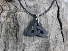 "This unique and intricate hand-carved Irish Bog Oak Celtic pendant will be made for you, or a loved one, in my studio on the West of Ireland. Bog Oak comes from ancient forests that once covered Ireland. Huge oaks have been buried in peat bogs and preserved from decay by the acidic and anaerobic bog conditions, sometimes for hundreds or even thousands of years. The wood is usually stained black by tannin dissolved in the acidic water. Bog-wood represents the early stages in the fossilization of Artisan Carved Black Necklace, Artisan Black Carved Necklace, Traditional Black Etched Jewelry, Artisan Black Carved Jewelry, Artisan Black Engraved Necklace, Black Artisan Engraved Jewelry, Black Etched Jewelry For Gifts, Black Etched Jewelry For Gift, Druid Jewelry