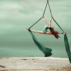 a woman hanging upside down on a hammock