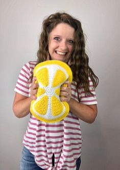 a woman holding a yellow and white object in her hands