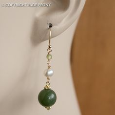 "Here is a simply elegant pair of green nephrite jade ball earrings set with white freshwater pearls and green peridot on 14kt gold fill hooks. The jade balls are about 10mm, the pearl is about 5mm, and the peridot is about 3mm. The earrings hang about 1 1/2\" Jade is the 35th annivesary stone and a good luck healing stone. - Gift packaging included - Ready to ship Please read our shop policies before committing to purchase: http://www.etsy.com/shop/jadepeony/policy If you have any questions, pl Classic Green Pearl Drop Jewelry, Green Round Classic Pearl Earrings, Green Round Pearl Drop Jewelry, Classic Green Pearl Earrings As Gift, Classic Green Pearl Earrings For Gift, Green Pearl Drop Jewelry With Round Beads, Elegant Jade Gemstone Beads Earrings, Green Pearl Drop Round Earrings, Green Round Pearl Drop Earrings