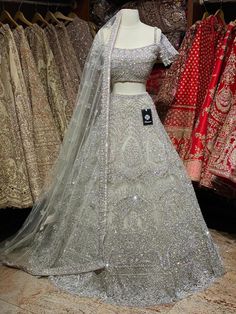 Iced cube sliver lehenga with frosted crystal embroidery teamed with a spaghetti strap blouse with crystal embroidery and net dupatta. Fabric: Net Custom designed according to client measurements and color preference. Production and delivery time is 120 days! Silver Hand Embellished Sharara For Wedding, Silver Party Wear Sets With Intricate Embroidery, Designer Silver Organza Lehenga, Silver Lehenga With Intricate Embroidery For Party, Silver Party Wear Lehenga With Intricate Embroidery, Silver Anarkali Style Hand Embellished Sharara, Silver Hand Embellished Lehenga For Wedding, Silver Embellished Organza Lehenga, Silver Hand Embellished Wedding Lehenga