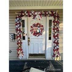 a christmas wreath on the front door of a house decorated with red, white and blue ribbon