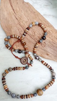 Extra long beautiful beaded strand of recycled African Glass, African Turquoise, Picture Jasper, Aventurine, Agate, shell disks, artisan beads, assorted natural and metal spacer beads, Java beads, coconut, and more. Very unique and earthy. Leather loop and coconut button closure. Necklace is a lovely display of textures and contrast. 30" in length but extendable to 31". The item/s pictured is the item you will receive. HavSolStudio on ETSY | Mixed media . Earthy elegance . Great texture . Beach Bohemian Jasper Beaded Necklaces With Gemstone Beads, Adjustable Hand-strung Nature-inspired Beaded Necklaces, Earthy Agate Beaded Necklaces With Round Beads, Hand-strung Nature-inspired Beaded Necklaces, Nature-inspired Beaded Necklace With Wooden Beads, Unique Adjustable 8mm Bead Necklaces, Nature-inspired Hand-strung Beaded Necklaces, Rustic Round Beads Jewelry For Meditation, Rustic Adjustable Jewelry With Polished Beads