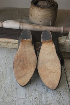 "A wonderful and unique pair of early French heels! These most likely date from the early 1900s, but they could be older. Such an interesting shoe design! ~ The sole is wooden with a great carved shape and the top is thick black leather with some of the shine left! There is fine embossed details on the top as well. There is a label on the shoe's interior that reads \"Manufacture de Galoche et Semelle's de Galoches\" and there is a brand logo for what looks like \"N.P.I.\". A very interesting pai Vintage Closed Toe Mules With Wooden Heel, Vintage Closed Toe Mules With Leather Sole, Vintage Open Toe Mules With Wooden Heel, Vintage Leather Sole Closed Toe Clogs, Vintage Leather Sole Slip-on Clogs, Vintage Clogs With Leather Sole And Closed Toe, Vintage Mules With Leather Sole And Round Toe, Vintage Closed Toe Clogs With Leather Sole, Vintage Open Toe Mules With Leather Sole