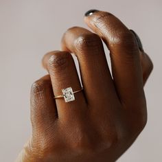 a woman's hand with a diamond ring on it