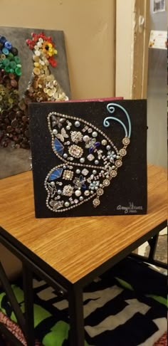 a card with a butterfly on it sitting on a table