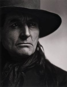 black and white photograph of an old man wearing a hat