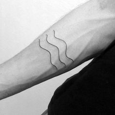 a black and white photo of a man's arm with wavy lines on it