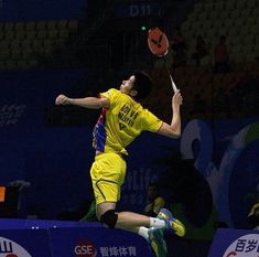 a man jumping in the air to hit a tennis ball