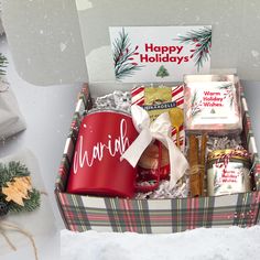 a holiday gift box with cookies, marshmallows and other treats in it