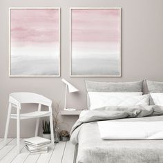 two paintings on the wall above a bed