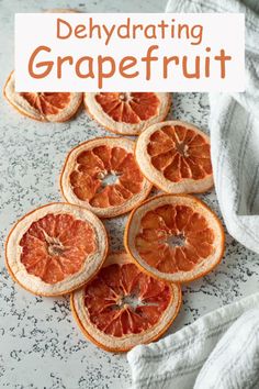 grapefruit sliced in half on a marble counter top with text overlay that reads dehydrating grapefruit