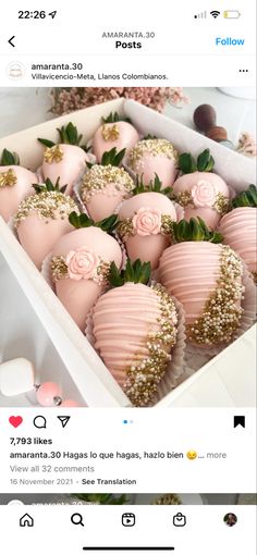 a box filled with lots of pink and gold covered strawberries next to each other