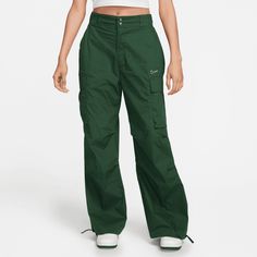 Style No. FV4969-323 Color: Fir Green Match functionality with throwback style in this fresh take on a favorite. These roomy utility pants feature cargo pockets for quick and easy storage. Their durable woven fabric is fully lined—but still lightweight. Plus, ties at the leg openings let you customize your look. Pockets provide quick storage for keys, phone and cold hands. Cinch ties at leg openings to show off your favorite kicks. Nike Sportswear Women's High-Waisted Loose Woven Pants. Nike Cargo Pants, Nike Sportswear Women, Cargo Pants Outfit, Green Cargo Pants, Green Cargo, Green Pants, High Rise Pants, Cargo Trousers, Nike Pants