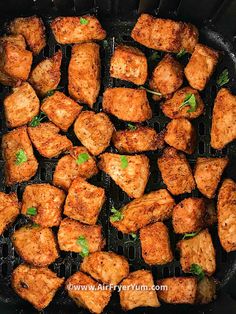 chicken cubes cooking in a skillet with parsley on the top and green garnish