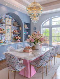 a dining room with blue walls and pink chairs