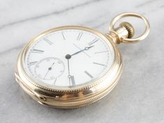 "This antique size 16 pocket watch was made by the Elgin watch company of Chicago in the year 1880. Edged with an outer dial and classic times new roman numerals, this piece features a second counting dial as well. The face of this piece is crisp white, the dials clear and the anodized hands have retained a sleek blue hue. The reverse of the case is engraved with a handsome monogram, the inside of the case is fitted with a secondary lid in the locket style, which has not been engraved and could Classic Pocket Watch With Stopwatch And Round Dial, Timeless Collectible Pocket Watch With Round Dial, Heirloom Round Pocket Watch With Chronometer, Collectible Timeless Pocket Watch With Round Dial, Antique Pocket Watch With Stopwatch, Timeless Collectible Pocket Watch With Subdials, Timeless Collectible Pocket Watch With Metal Dial, Vintage Yellow Gold Pocket Watch With Skeleton Dial, Heirloom Round Chronometer Pocket Watch