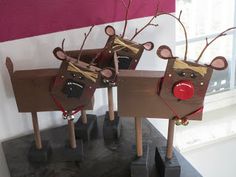 three wooden reindeer decorations on top of a table