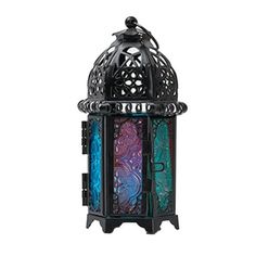 an ornate metal lantern with blue and green glass panels on the front, sitting against a white background