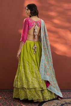 Lime green layered lehenga with floral embroidered motifs and side tassel tie-up. Paired with embroidered blouse and floral printed, embroidered dupatta. The lehenga comes with an attached can can.
Component: 3
Embroidered
Neckline: V neck
Sleeve Length: Three quarter
Fabric: Printed Zari, Chanderi
Color: Green, Pink
Back tassel tie-up
Embroidered blouse
Scallop border
Can Can attached to lehenga
Note: Potli bag shown in the image is not for sale - Aza Fashions Green Embroidered Raw Silk Lehenga, Green Chanderi Choli With Intricate Embroidery, Embroidered Green Raw Silk Lehenga, Green Raw Silk Choli With Intricate Embroidery, Transitional Green Dola Silk Choli, Green Raw Silk Choli With Cutdana, Designer Green Choli With Intricate Embroidery, Green Bollywood Lehenga With Floral Embroidery, Bollywood Style Green Lehenga With Floral Embroidery