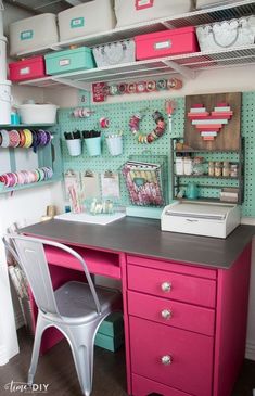 an organized craft room with pink and green drawers, white shelves, and lots of crafting supplies