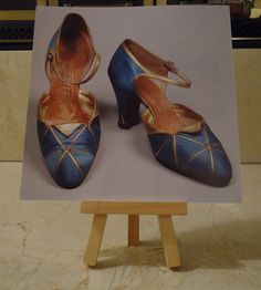 "This notebook will be made using a picture of a pair of blue and gold flapper shoes, which I cut from a calendar, as the front cover.  (Caption:  \"Silk satin d'Orsay flapper shoes with metallic leather trim, Andre Perugia, 1920s.\")  The back cover will be made of durable white posterboard.  Inside will be fifty pages of white, unlined paper.  I can also use lined notebook paper upon request.  I have two colors of coil available--white or clear.  If you have a preference of which color let me know; otherwise, I will use whichever I think looks better with the picture. I got the idea for my notebooks when I saw all the calendars being thrown away at the seasonal calendar store where I worked.  I thought a lot of the images would make great notebook covers.  I was able to take some of the 1920s Flapper Shoes, Lined Notebook Paper, Flapper Shoes, Gold Flapper, Mini Notebooks, 1920s Flapper, Happy Things, Lined Notebook, Notebook Paper