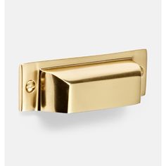 a gold door handle on a white wall