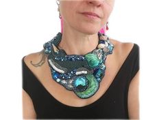 Statement necklace with dolphin Opulent statement chain for special occasions.Beads, shells, silk and crystal were elaborately crafted by hand.Get this handmade unique piece now!Measures: close-fitting, fits up to a neck circumference of 15,74"Material: Alcantara imitation fabric, rocailles, resin, metal, shells, shibori silk, extension chainNo tax statement according to German small business regulation §19 Turnover Tax Act.Deliveries outside Germany may be subject to customs and import sales ta Elegant Handmade Blue Shell Necklace, Shells And Pearls, Shibori Silk, Bib Necklaces, Necklace Blue, Blue Necklace, Bib Necklace, Shibori, Boho Jewelry