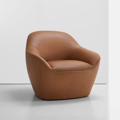 a brown chair sitting on top of a white floor