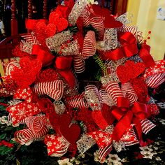 a red and white heart wreath on top of a table