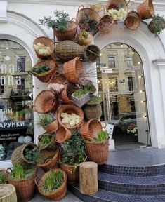 several baskets are stacked on top of each other in front of a building with stairs