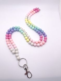 These gorgeous lanyards are made with 10mm beads. We use high quality bead wire which allows you to move throughout your day without worrying about the strength of your lanyard. Each lanyard is 34 inches long, includes a keyring and lobster claw, and can be personalized to include your name or any other saying. You can choose from four different bead colors for personalization and add on a tassel too! ⭐️if you prefer your lanyard to be short or longer send me a message and we can accommodate. ⭐️ Colorful Round Beads Necklace, White Lanyard With Colorful Beads For Gifts, Gift Beaded Chain Lanyard, White Lanyard With Colorful Beads As Gift, Multicolor Round Bead Jewelry For Personal Use, Handmade Pink Beaded Lanyards, Pink Round Beads Necklace For Personal Use, Multicolor Personalized Lanyards With Round Beads, Personalized Multicolor Lanyards With Round Beads