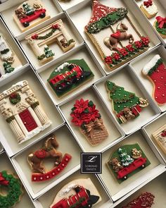 many decorated cookies in boxes with christmas decorations on them, including stockings and stocking