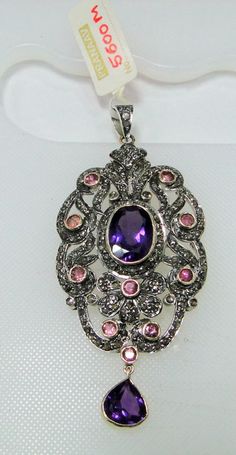 ITEM-VICTORIAN DIAMOND Amethyst Rubelite, 14 CT GOLD & STERLING SILVER PENDANT. SIZE-8/3.5 CM, TOTAL WEIGHT-15 GRAMS, Amethyst WEIGHT-17.5 CT, Rubelite Weight-4 ct, OLD CUT FLAT ROUND DIAMOND WEIGHT-6.80 CT, 14 CT GOLD WEIGHT-4.400 GMS ALL STONES ARE NATURAL AND OF HIGH QUALITY. MATERIAL-14 CT SOLID GOLD, SILVER, DIAMOND, Amethyst, Rubelite Gemstones. Luxury Silver Necklace With Stone Setting, Luxury Sterling Silver Necklace With Stone Setting, Luxury Sterling Silver Necklaces With Stone Setting, Elegant Purple Multi-stone Necklaces, Elegant Purple Multi-stone Necklace, Elegant Multi-stone Oval Pendant Jewelry, Silver Gemstones With Jewels In Fine Jewelry Style, Multi-stone Amethyst Pendant Jewelry, Amethyst Multi-stone Pendant Jewelry