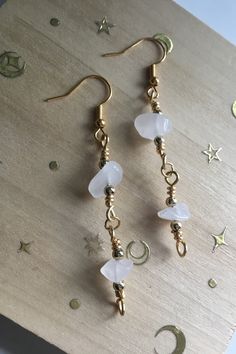 White Quartz, crystal chip, natural stone, dangly earrings with gold plated hooks, anti tarnish gold colour metal wire which has been wire wrapped throughout, and white quartz crystal chip beads. A simple and lightweight elegant design for everyday wear that will add a holistic boho style vibe to any outfit whilst wearing the additional crystal properties of the white quartz chips. These are roughly 2inches long. White Stone Jewellery, White Stone Jewelry, White Quartz Crystal, Boho Earring, Wire Wrapped Crystal, Wrapped Crystal, Stone Jewellery, Wire Wrapping Crystals, Earring Gift