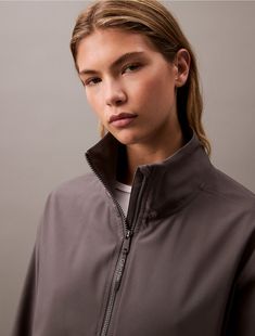 Minimalist with a solid body, this performance jacket is constructed from moisture-wicking fabric for total comfort and breathability during workouts. Created with a zip closure at the front and a stand collar. Detailed with elastic sleeve cuffs and finished with repeating Calvin Klein logos at the hem.  Material: 92% Polyester, 8% Elastane. A Stand, Moisture Wicking Fabric, Windbreaker Jacket, Stand Collar, Moisture Wicking, Calvin Klein, Elastic, Collar, Fabric