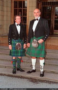 two men in kilts standing next to each other