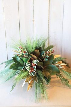 a bouquet of flowers sitting on top of a wooden table next to a white wall