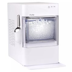 a white ice maker sitting on top of a counter next to an ice ball dispenser